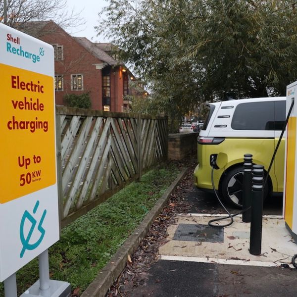 An electric Volkswagen ID.Buzz at a Shell rapid charger in a car park